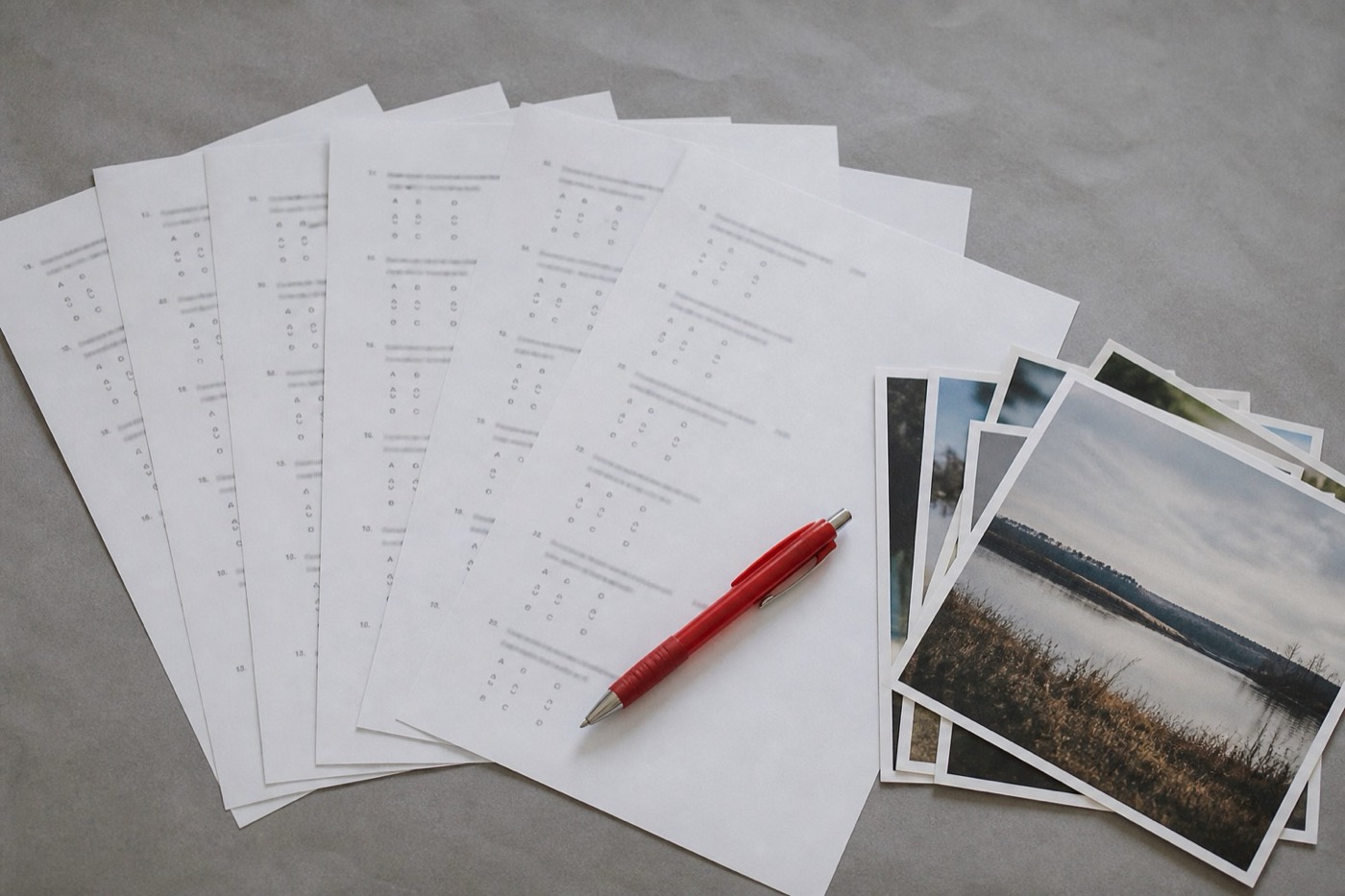 Printed quiz sheets and photo prints on a desk